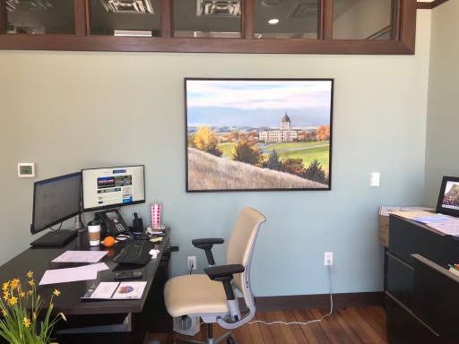 This scenic painting by Jim Sturdevant helps to open up the work space by creating a faux window view.